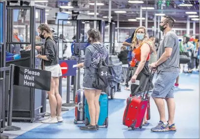  ?? L.E. Baskow Las Vegas Review-journal @Left_eye_images ?? The TSA increased health and safety protocols at Mccarran Internatio­nal Airport, such as installing 72 acrylic barriers.