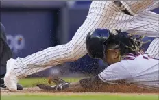  ?? AP photo ?? The Guardians’ Jose Ramirez dives safely into third base after hitting a double and advancing on a throwing error in the 10th inning against the Yankees on Friday.