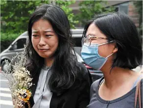  ?? — AFP ?? Zhou, a feminist figure who rose to prominence during China’s #metoo movement, walks with a supporter before attending a hearing in her sexual harassment case.