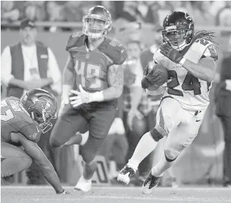  ??  ?? Falcons running back Devonta Freeman runs past Buccaneers safety Keith Tandy, left, and linebacker Riley Bullough for a 32-yard touchdown on Monday.