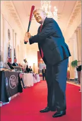  ?? AFP ?? ■
US President Donald Trump takes a swing with a bat from Texas Timber before speaking at a Spirit of America showcase event on small businesses at the White House, in Washington, DC.