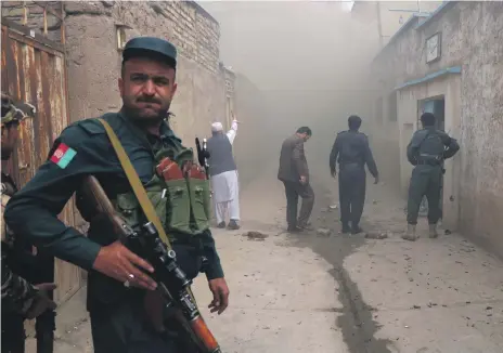  ?? Reuters ?? An Afghan police officer stands guard outside the mosque in Herat where ISIL launched a suicide attack yesterday