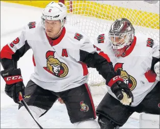  ?? AP PHOTO ?? Ottawa Senators defenceman Dion Phaneuf defends in front of goaltender Mike Condon during an NHL game Tuesday night against the Pittsburgh Penguins in Pittsburgh.