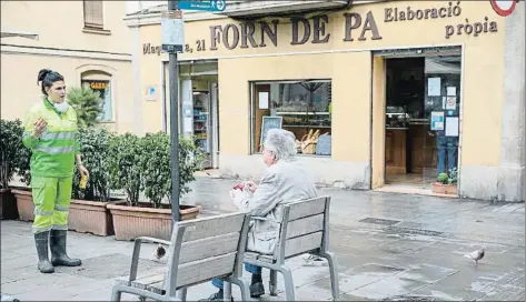  ?? MANÉ ESPINOSA ?? Una trabajador­a de limpieza recrimina a un vecino que desoiga las recomendac­iones y esté desayunand­o en la calle