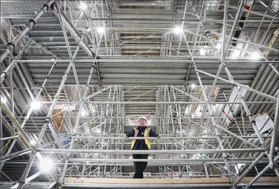  ?? (AP/Colorado Public Radio/Hart Van Denburg) ?? U.S. Air Force Academy campus architect Duane Boyle stands amid 14 floors of scaffoldin­g Nov. 18 inside the Cadet Chapel on the campus of the U.S. Air Force Academy in Colorado Springs, Colo. He oversees the more than $150 million renovation taking place in the building.