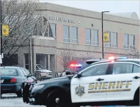  ?? SUSAN WALSH THE ASSOCIATED PRESS ?? Police converge on Great Mills High School, Tuesday in Great Mills, Md. .