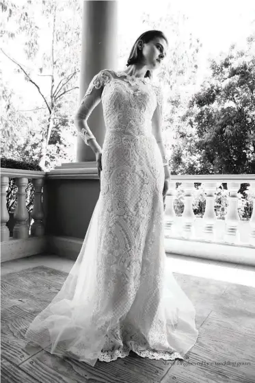  ??  ?? Sheer longleeved lace wedding gown.