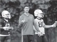  ??  ?? UTC football coach Tom Arth instructs players during his team’s first spring practice on Saturday.