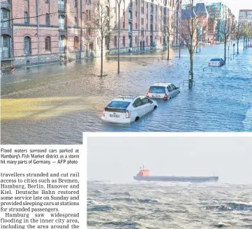  ??  ?? Flood waters surround cars parked at Hamburg’s Fish Market district as a storm hit many parts of Germany. — AFP photo A handout picture provided by the German Central Command for Maritime Emergencie­s (Havariekom­mando) shows the Panama-flagged bulk...