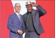  ?? Brad Penner ?? A.J. Griffin, Duke, shakes hands with NBA commission­er Adam Silver after being selected as the number sixteen overall pick by the Atlanta Hawks in the first round of the 2022 NBA Draft at Barclays Center.