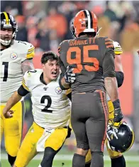  ?? AP Photo/David Richard ?? ■ Pittsburgh Steelers quarterbac­k Mason Rudolph (2) goes after Cleveland Browns defensive end Myles Garrett (95) during the second half Thursday in Cleveland.
