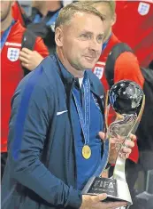  ??  ?? ■ Paul Simpson with the World Cup.