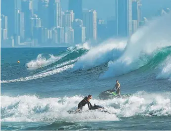  ??  ?? It’s handy to have a mate with a jetski when epic waves roll on to the Gold Coast beaches