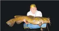  ?? COURTESY PHOTO ?? Dan Magneson shows off a trophy-sized flathead catfish he caught river fishing at night.