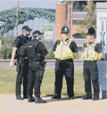  ??  ?? Police, including armed officers, on duty in Sunderland.