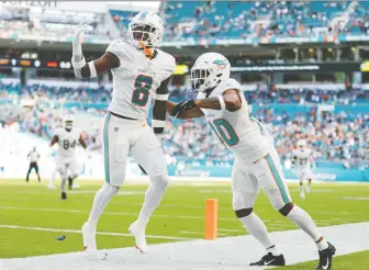  ?? SAM NAVARRO/USA TODAY SPORTS ?? Miami Dolphins free safety Jevon Holland, left, who was born in Canada, is having an outstandin­g rookie season with the team and has started seven of nine games so far.