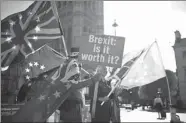  ?? HENRY NICHOLLS / REUTERS ?? Anti-Brexit protesters wave flags outside the Houses of Parliament in London.