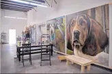  ??  ?? Several huge paintings of euthanized dogs by Mark Barone cover the walls of warehouse/ studio space off Siler Road.