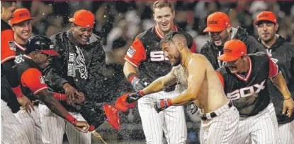  ?? | AP ?? Second baseman Yolmer Sanchez ( shirtless) celebrates with teammates after driving in the winning run Friday against the Tigers.