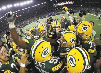  ?? Ezra Shaw / Getty Images ?? The Packers celebrate after Mason Crosby’s field goal as time expired beat the Cowboys in Arlington, Texas. The kick came the play after Aaron Rodgers’ 36-yard pass to Jared Cook.