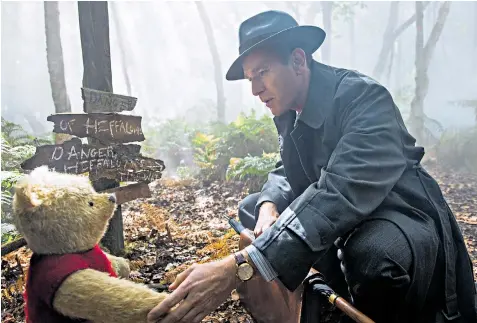  ??  ?? Friends reunited: Ewan Mcgregor plays a grown-up Christophe­r Robin who meets his favourite childhood toy again
