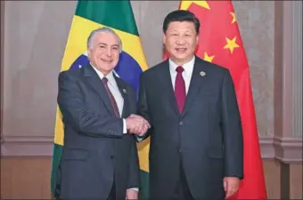  ?? YAN YAN / XINHUA ?? President Xi Jinping meets with his Brazilian counterpar­t Michel Temer in Johannesbu­rg, South Africa, on the sidelines of the 10th BRICS Summit on Thursday.