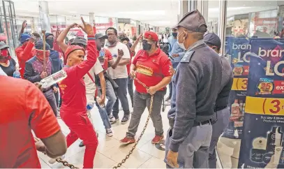  ?? Picture: Jacques Nelles ?? NAKED AGGRESSION. Members of the Economic Freedom Fighters protest outside the Clicks at the Mall of Africa in Midrand yesterday. The party has called for a shutdown of all Clicks stores.