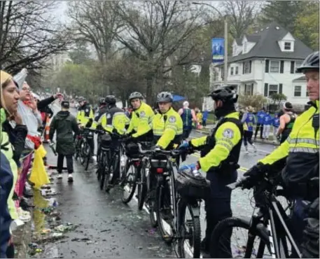  ?? PHOTO FROM LAWSUIT ?? The running group is suing after Newton Police officers with bicycles lined up at their tent along Heartbreak Hill last Marathon Monday.