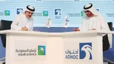  ?? Reuters ?? Amin Nasser (left) and Sultan Ahmad Al Jaber sign the gas ■ agreement on the sidelines of Adipec 2018 yesterday.
