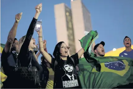  ??  ?? People attend a protest in support of a truck drivers’ strike and against Brazilian President Michel Temer’s government in Brasilia on Monday.