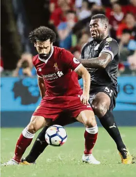  ??  ?? Flying high: Liverpool’s Mohamed Salah (left) fights for the ball with Leicester’s Wes Morgan during the Premier League Asia Trophy tournament in Hong Kong on July 22. — AP