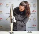  ?? MAHE/REUTERS STEPHANE ?? ArcelorMit­tal employee Camille Eudeline holds a torch for the Paris 2024 Olympic and Paralympic Games on Nov. 17 in Vire, France.
