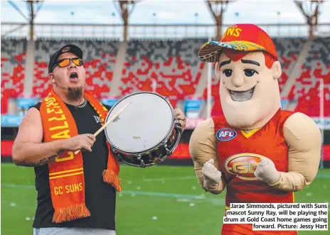  ??  ?? Jarae Simmonds, pictured with Suns mascot Sunny Ray, will be playing the drum at Gold Coast home games going forward. Picture: Jessy Hart