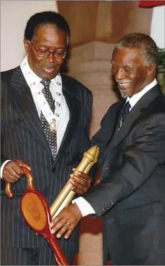  ?? ?? Honoured: Dingake receiving The Grand Companion of the Order of the Companies of OR Tambo in Gold from former SA president Thabo Mbeki