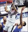  ?? David Butler II / Associated Press ?? UConn’s Jalen Gaffney ( 0) shoots against Seton Hall during the first half of Saturday’s game.