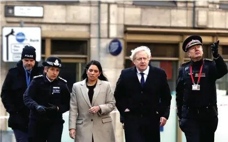  ?? — Reuters photo ?? Johnson (second right), Home Secretary Priti Patel, Dick and City of London commission­er Ian Dyson (right) arrive at the scene of a stabbing on London Bridge, in which two people were killed, in London, Britain.