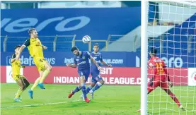  ?? ?? Sajid Dhot heads the ball home to give Chennaiyin FC the lead; (left) CFC players Ariel Borysiuk and Deepak Devrani in traditiona­l attire as the team celebrates Pongal