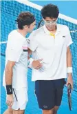  ??  ?? INJURED: Roger Federer (left) consoles Hyeon Chung.