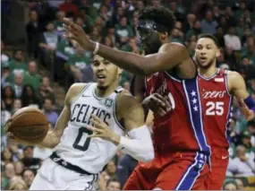  ?? ELISE AMENDOLA - AP ?? Boston Celtics forward Jayson Tatum (0) drives against Philadelph­ia 76ers center Joel Embiid (21) as 76ers guard Ben Simmons (25) looks on in the second half of Game 1 of an NBA basketball second-round playoff series, Monday, in Boston. The Celtics won...