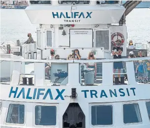  ?? ANDREW VAUGHAN THE CANADIAN PRESS FILE PHOTO ?? Passengers wear face masks on a Halifax Transit ferry as it arrives in Dartmouth, N.S., on July 24. On July 31, Nova Scotians were expected to wear masks in most indoor public spaces.