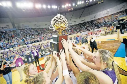  ?? [SARAH PHIPPS/ THE OKLAHOMAN] ?? Hydro-Eakly celebrates with the gold ball trophy after winning the Class A girls basketball state title at Jim Norick Arena on March 7, 2020.