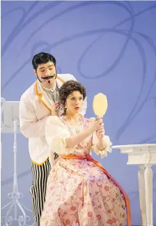  ?? DAVID COOPER PHOTO ?? Clarence Frazer as Figaro and Sylvia Szadovszki as Rosina in Pacific Opera Victoria’s production of The Barber of Seville.