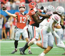  ?? KEVIN C. COX/GETTY ?? Georgia quarterbac­k Stetson Bennett throws a pass during the first quarter against Ohio State in the Peach Bowl at Mercedes-Benz Stadium in Atlanta.