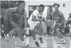  ?? JOSEPH SCHELLER/COLUMBUS DISPATCH ?? Pickeringt­on Central’s Juwan Turner charges past Africentri­c’s Preston Steele on Jan. 21. Central is the top seed in the Division I district tournament, and Africentri­c is seeded first in Division III.