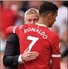  ??  ?? HUG TIME: Ronaldo and Solskjaer