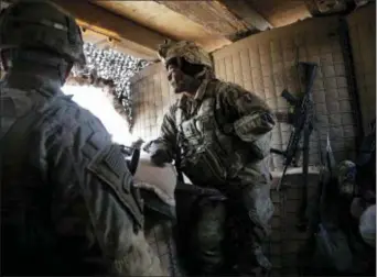  ?? SUSANNAH GEORGE — THE ASSOCIATED PRESS ?? In this Friday photo, U.S. Army Sgt. Kaylin Jones, 25, stands at a guard tower on the perimeter of a small coalition outpost on the western edge of Iraq. A few hundred American troops are stationed at a small outpost near the town of Qaim along Iraq’s...