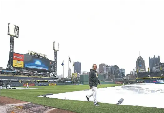  ?? Peter Diana/Post-Gazette ?? Pittsburgh Pirates manager Clint Hurdle walks in PNC Park checking the weather prior to warmups on April 7.