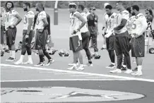  ?? TONY GUTIERREZ/THE ASSOCIATED PRESS ?? Texans players wait to run sprints Monday at the Dallas Cowboys training facility in Frisco, Texas. The Texans are working out in Frisco because of floods pounding Houston. An exhibition game between the teams planned for Houston on Thursday has been moved to Dallas.