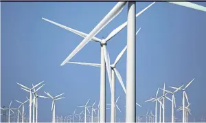  ??  ?? Wind turbines for generating electricit­y are seen in Guazhou in Gansu province of China.