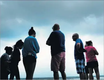  ?? Spencer Platt Getty Images ?? PEOPLE HANG out at the beach in Naples, which is set to feel the storm’s fury by midafterno­on Sunday. A mass evacuation order came too late for many on Florida’s western coast to f lee as the storm changed course.